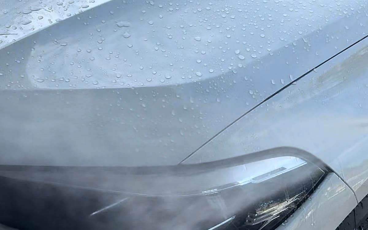 Water beading across the freshly waxed hood of a white SUV